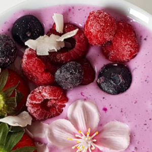 Pink pitaya bowl met rood fruit